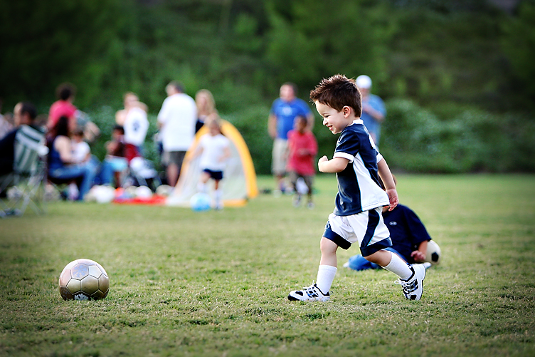Soccer kid kicking soccer ball